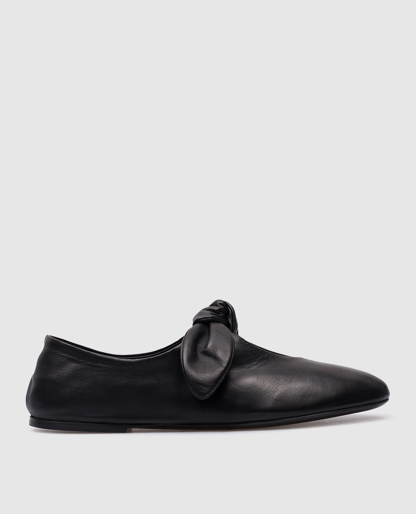 Black leather ballet flats with a bow