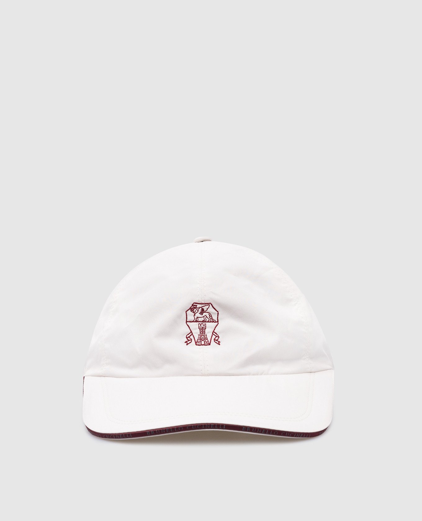 White cap with embroidered logo emblem
