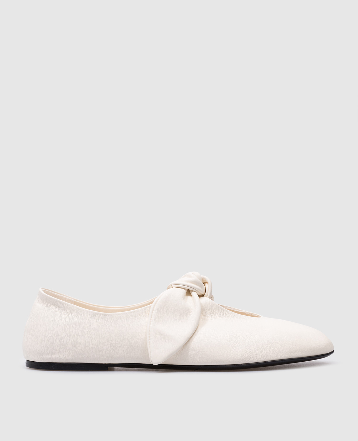 White leather ballet flats with a bow