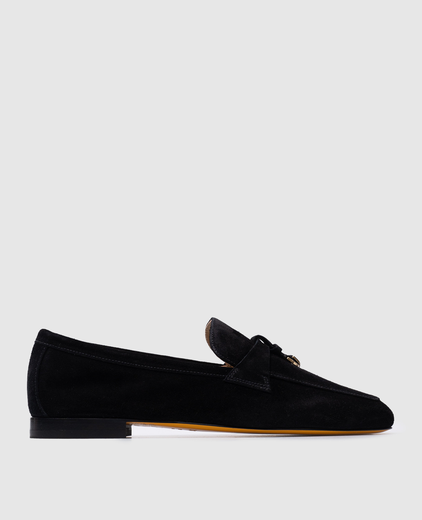 Black suede loafers with metal pendants