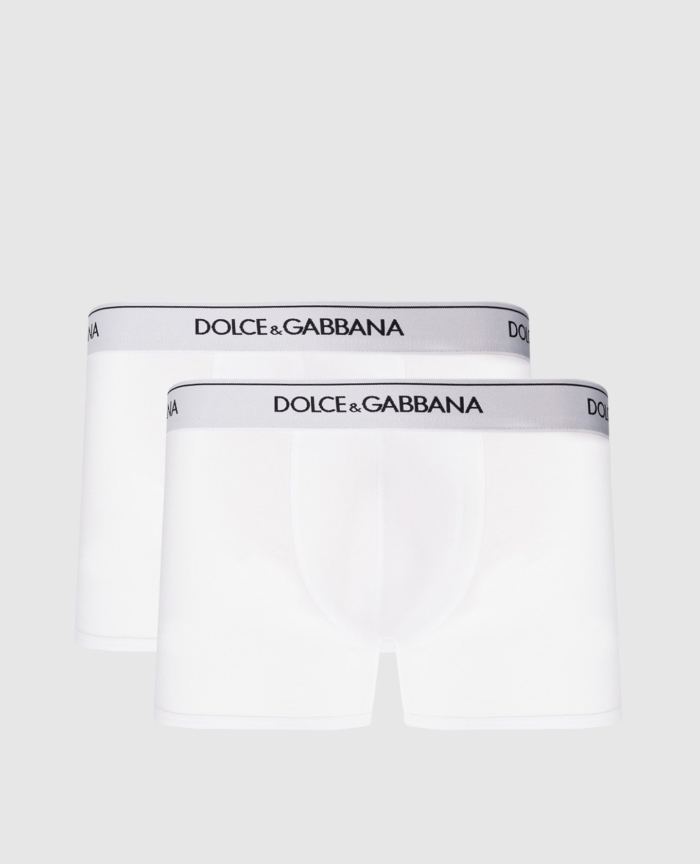 A set of white boxer briefs with a logo pattern